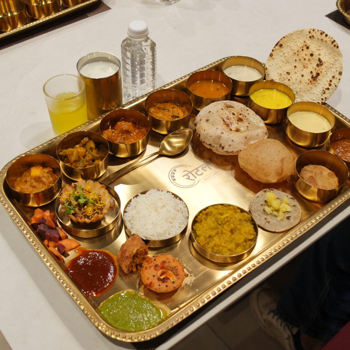 Rotlo's signature brass thali — authentic Gujarati spread